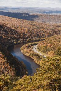 A breathtaking aerial view of Delaware Water Gap, PA with vibrant fall foliage and winding river.